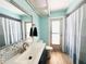 Bathroom featuring patterned tile accents, a white vanity, and a shower with a curtain at 13290 75Th Ave, Seminole, FL 33776