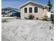 This home features rock landscaping, enhancing its curb appeal and low-maintenance yard at 13331 1St E St, Madeira Beach, FL 33708