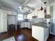 Bright kitchen featuring white cabinetry, an island, and modern pendant lights at 13331 1St E St, Madeira Beach, FL 33708