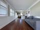 Spacious living room featuring wood floors and a gray sofa at 13331 1St E St, Madeira Beach, FL 33708