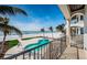 A resort-style backyard with a beautiful pool, manicured lawn and beach access, offers an ultimate in outdoor living at 15912 Gulf Blvd, Redington Beach, FL 33708