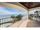 Covered balcony overlooking ocean, enhanced with tile flooring and wrought iron railing, great for relaxation at 15912 Gulf Blvd, Redington Beach, FL 33708