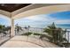 Relaxing balcony view showcases ocean vista with palm trees enhancing the serene ambiance at 15912 Gulf Blvd, Redington Beach, FL 33708