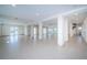 Large unfinished basement with white walls, concrete floor and multiple access doors to the outside at 15912 Gulf Blvd, Redington Beach, FL 33708