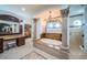 Opulent bathroom featuring a soaking tub, marble columns, and elegant fixtures at 15912 Gulf Blvd, Redington Beach, FL 33708