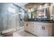 Modern bathroom with glass shower, double vanity, and marble-look tile at 15912 Gulf Blvd, Redington Beach, FL 33708