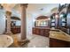 Elegant bathroom showcasing marble floors, custom cabinetry, granite counters, and a soaking tub at 15912 Gulf Blvd, Redington Beach, FL 33708