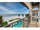 Balcony view of a beachfront property featuring a pool, palm trees, and ocean views at 15912 Gulf Blvd, Redington Beach, FL 33708