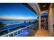 Sunset view from a balcony overlooking the beach with a pool, palm trees, and the evening sky at 15912 Gulf Blvd, Redington Beach, FL 33708