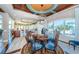 Bright dining area featuring custom lighting, large windows, and an open view of the kitchen at 15912 Gulf Blvd, Redington Beach, FL 33708