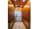 Interior of the elevator featuring wood paneling and tile flooring at 15912 Gulf Blvd, Redington Beach, FL 33708