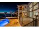 Exterior view of luxury home featuring balcony, pool and ocean views at dusk at 15912 Gulf Blvd, Redington Beach, FL 33708