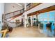 Grand foyer featuring a staircase with iron railing, stone floors, and a view of the ocean at 15912 Gulf Blvd, Redington Beach, FL 33708