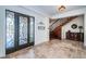 Foyer with stone floors, ornate front door, staircase and storage cabinet at 15912 Gulf Blvd, Redington Beach, FL 33708