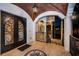 A grand front entrance with an arched doorway, stained glass, columns and patterned tile flooring at 15912 Gulf Blvd, Redington Beach, FL 33708