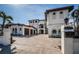 Elegant exterior view of the house with a three-car garage and meticulously paved driveway during the day at 15912 Gulf Blvd, Redington Beach, FL 33708