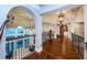 An expansive hallway with hardwood floors, decorative railings, and ocean view windows at 15912 Gulf Blvd, Redington Beach, FL 33708