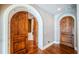 Arched doorway showcases the home's design, leading to rooms with hardwood floors and elegant accents at 15912 Gulf Blvd, Redington Beach, FL 33708