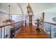 Elegant hallway features decorative wrought iron railing and ornamental chandeliers, adding sophisticated charm to the home's interior at 15912 Gulf Blvd, Redington Beach, FL 33708