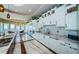 Bright kitchen featuring a marble island, stainless appliances, custom cabinets and plant accents at 15912 Gulf Blvd, Redington Beach, FL 33708