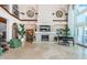 Spacious living room featuring stone fireplace, piano, and floor-to-ceiling windows, and decorative art at 15912 Gulf Blvd, Redington Beach, FL 33708