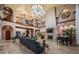 Elegant living room with tall ceilings, a stone fireplace, and a grand staircase at 15912 Gulf Blvd, Redington Beach, FL 33708