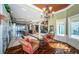 Elegant living room with marble floors, chandelier, and seating area showcases the home's luxury and open design at 15912 Gulf Blvd, Redington Beach, FL 33708