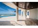 Covered patio view of a beachfront pool, with travertine pavers and beautiful beachfront vista at 15912 Gulf Blvd, Redington Beach, FL 33708