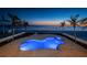 Beautiful outdoor pool and spa overlooking ocean at dusk at 15912 Gulf Blvd, Redington Beach, FL 33708