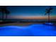 Swimming pool at sunset with a beachfront view, highlighted with blue lights in the evening at 15912 Gulf Blvd, Redington Beach, FL 33708