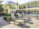 Relaxing courtyard featuring lounge chairs, beautiful landscaping, and a view of the condo building at 16333 Gulf Blvd # 105, St Petersburg, FL 33708