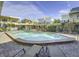 Community pool with brick patio and lounge chairs at 16333 Gulf Blvd # 106, St Petersburg, FL 33708