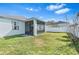 Backyard view featuring a screened lanai, providing an ideal space for outdoor relaxation and entertainment at 1645 Fennsbury Ct, Wesley Chapel, FL 33544