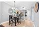 Bright dining area featuring tile floors, pendant lighting, and adjacent kitchen view at 1645 Fennsbury Ct, Wesley Chapel, FL 33544