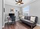 Cozy home office with a futon, desk, bookshelf, ceiling fan and neutral wall color at 1645 Fennsbury Ct, Wesley Chapel, FL 33544