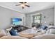 Spacious living room showcasing sliding glass doors to the outdoor space and modern ceiling fan at 1645 Fennsbury Ct, Wesley Chapel, FL 33544