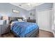 Cozy primary bedroom with dark wood furniture, blue walls, ceiling fan, and hardwood floors at 1645 Fennsbury Ct, Wesley Chapel, FL 33544