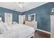 Bright main bedroom featuring dark wood floors, ensuite bathroom, and ample dresser storage at 1645 Fennsbury Ct, Wesley Chapel, FL 33544