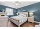 Charming main bedroom featuring dark wood floors and abundant natural light at 1645 Fennsbury Ct, Wesley Chapel, FL 33544