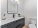 Modern bathroom with dark vanity and a floating shelf at 167 83Rd N Ave, St Petersburg, FL 33702