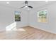 Bright bedroom with hardwood floors and two windows at 167 83Rd N Ave, St Petersburg, FL 33702