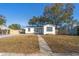 Charming single-story home with a well-manicured lawn and a quaint walkway leading to the front door at 167 83Rd N Ave, St Petersburg, FL 33702