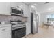 Updated kitchen featuring stainless steel appliances and white cabinets at 167 83Rd N Ave, St Petersburg, FL 33702