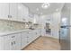 Modern kitchen with white shaker cabinets and stainless steel appliances at 167 83Rd N Ave, St Petersburg, FL 33702