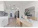 Open kitchen with white cabinets, quartz counters, and herringbone backsplash at 167 83Rd N Ave, St Petersburg, FL 33702