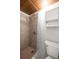 Bathroom with tiled shower, vintage cabinet, and basic toilet at 1672 Cambridge Dr, Clearwater, FL 33756