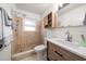 Bathroom featuring tiled shower, modern vanity, and updated fixtures at 1672 Cambridge Dr, Clearwater, FL 33756