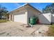 Attached garage with driveway; white picket fence at 1672 Cambridge Dr, Clearwater, FL 33756