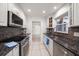 Bright kitchen with granite counters, stainless appliances, and stylish backsplash at 1672 Cambridge Dr, Clearwater, FL 33756