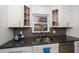 Close-up of the kitchen sink with granite counters and white cabinetry at 1672 Cambridge Dr, Clearwater, FL 33756